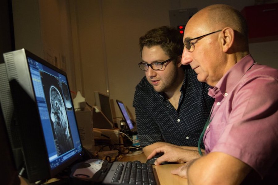 Two people looking at a scan on a computer