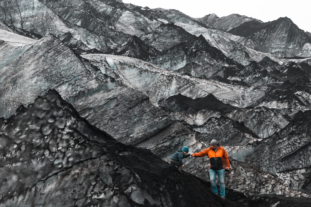 Picture of two people climbing some rocks