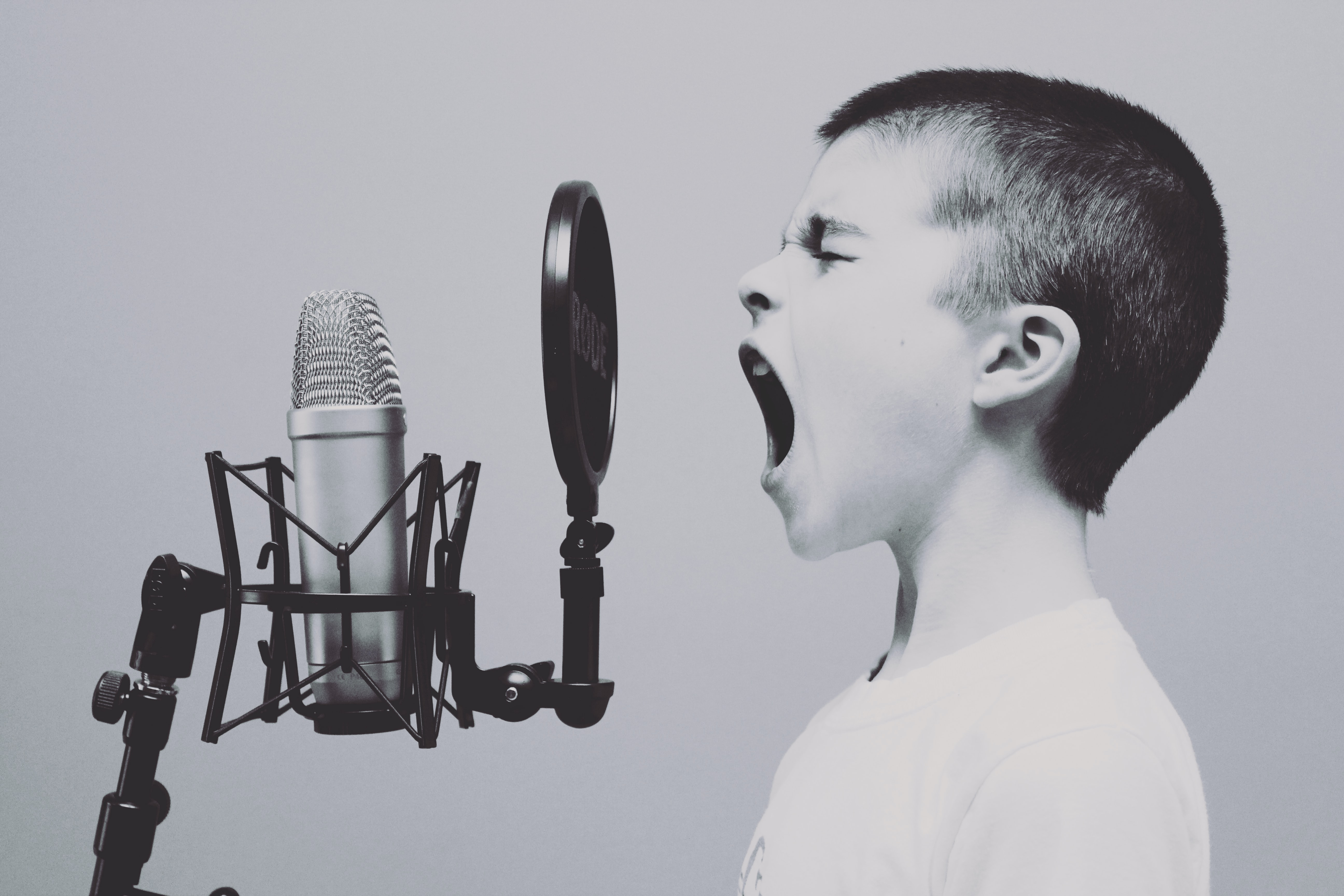 Picture of a boy singing into a microphone
