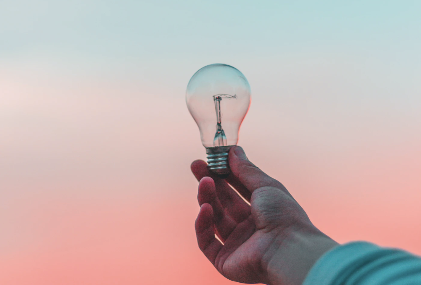 Picture of a lightbulb with a sunset in the background