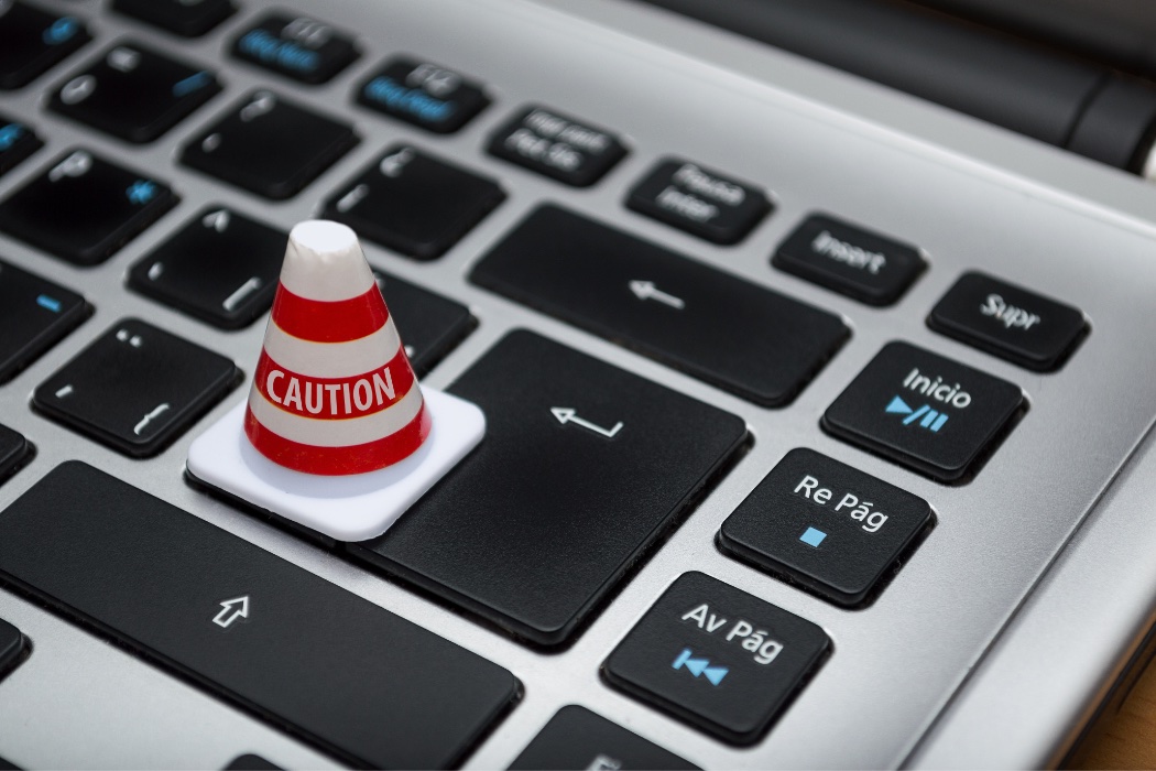Picture of a tiny hazard cone on a computer keyboard